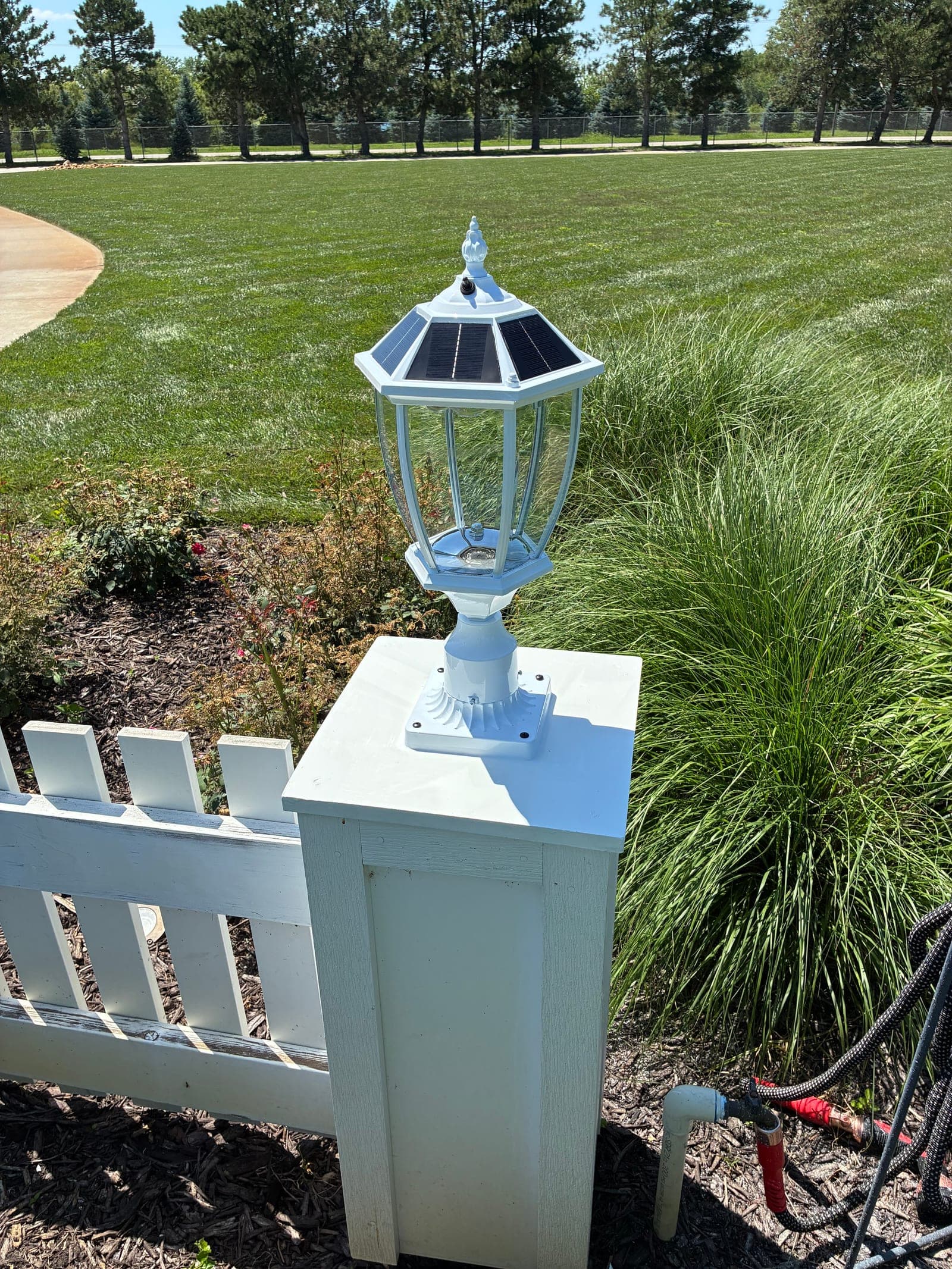 New solar-powered lantern finial installed on the fence post